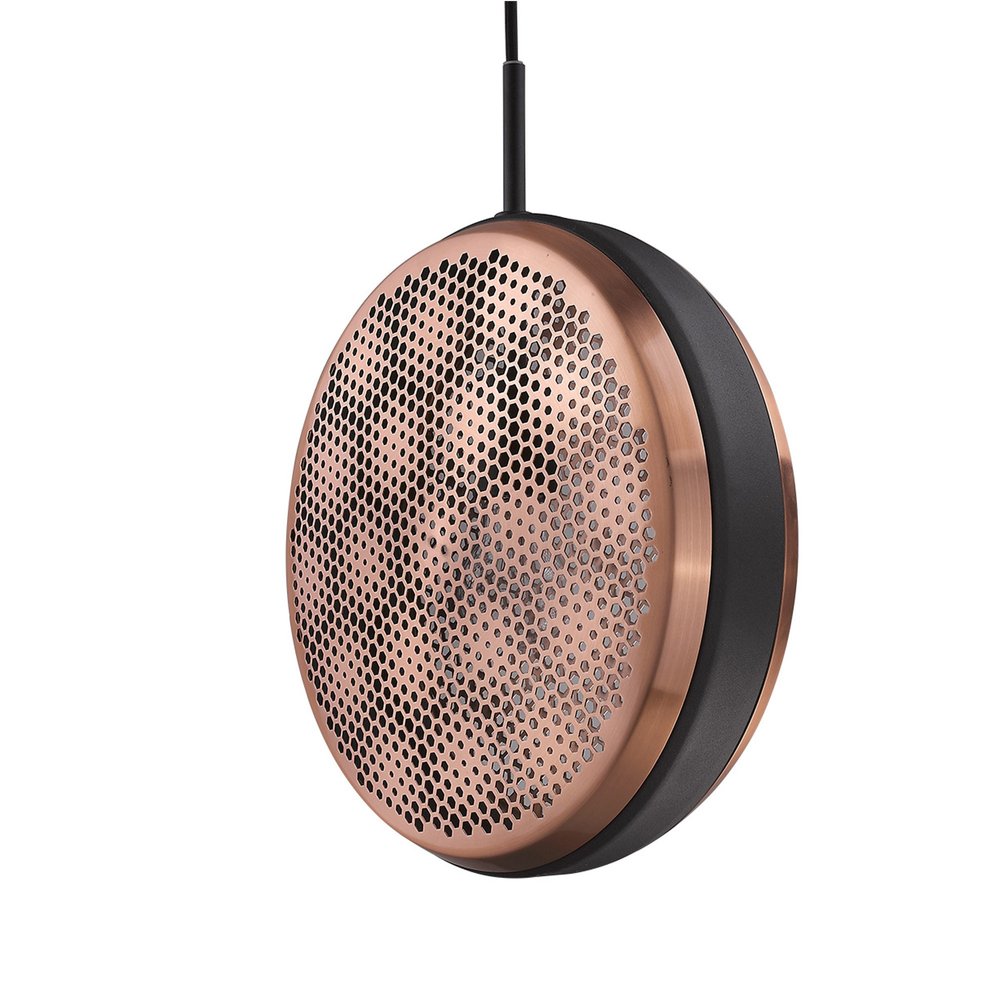 Round copper pendant light with a perforated honeycomb pattern and matte black trim, hanging from a black cord against a white background.