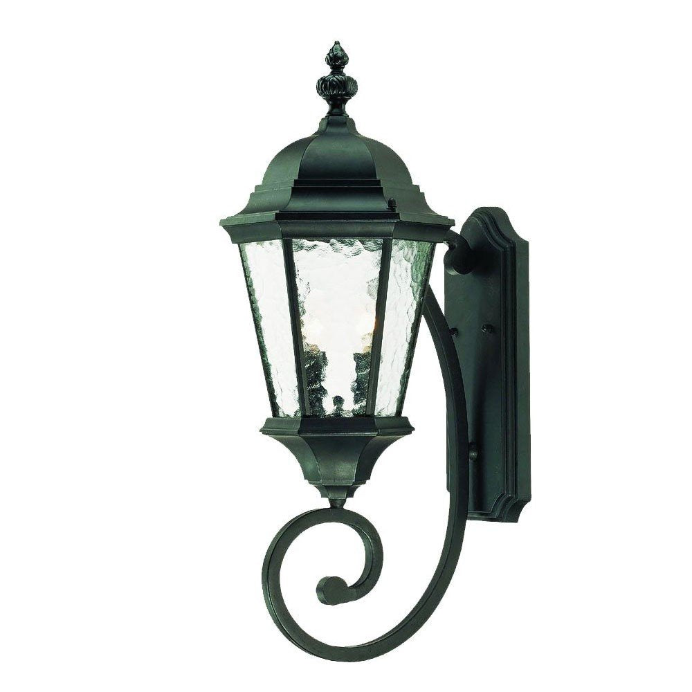 Matte black metal wall lantern with textured glass panels and a decorative scroll arm, mounted on a white background.