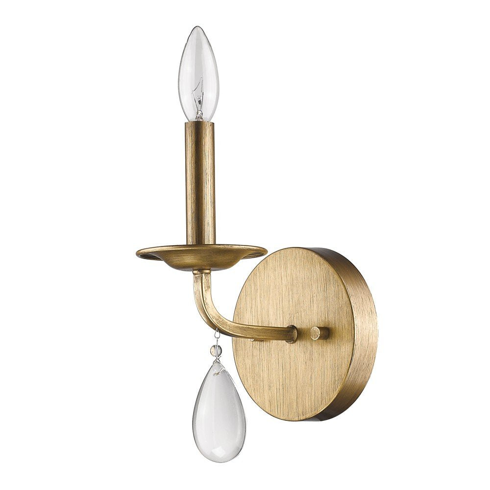 A light gold wall sconce with a clear teardrop crystal accent and a clear candle-shaped bulb on a white background.