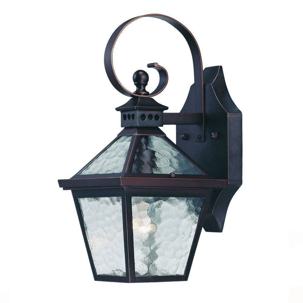 Antique bronze outdoor wall light with hammered glass panels and a decorative scroll arm, set against a white background.
