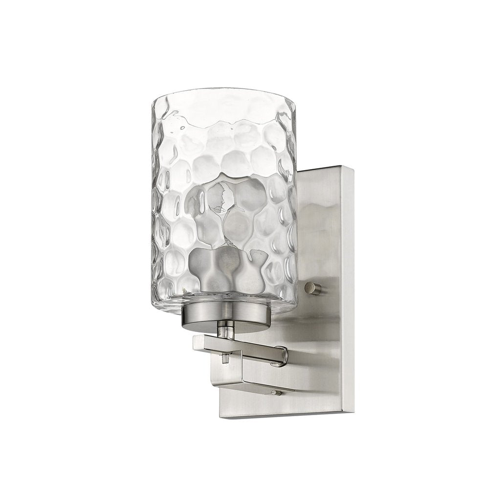Brushed nickel metal wall sconce with a clear pebbled glass shade on a white background.