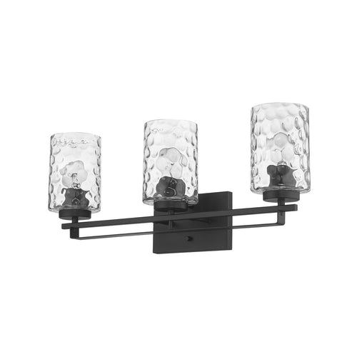 Black metal vanity light fixture with three clear textured glass shades against a white background.