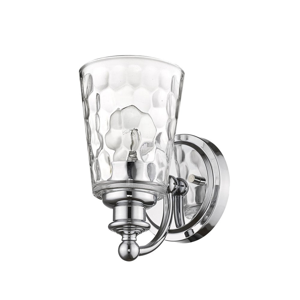 Chrome metal wall light with a clear pebbled glass shade and exposed bulb on a white background.