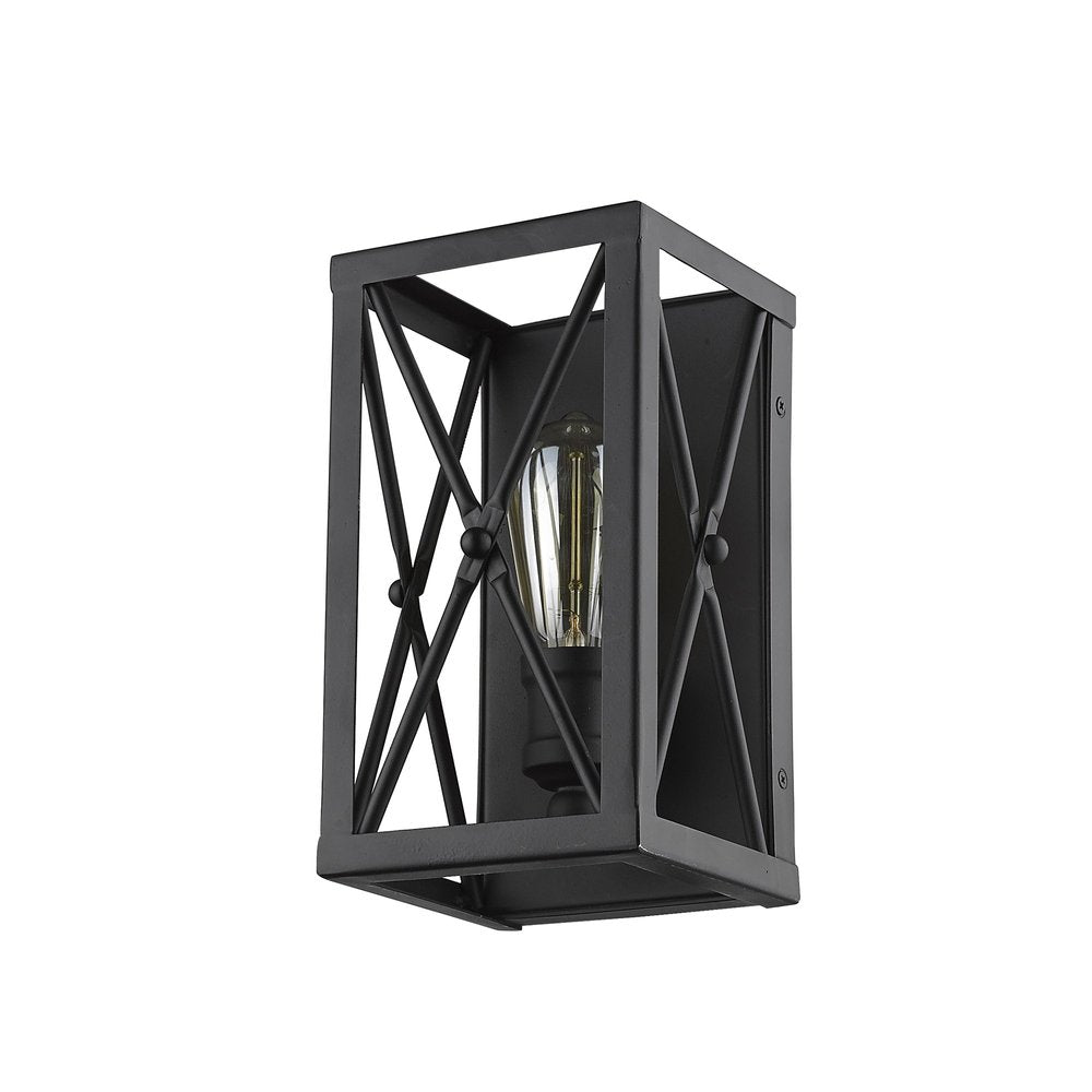 Matte black metal geometric wall light with exposed Edison bulb against a white background.
