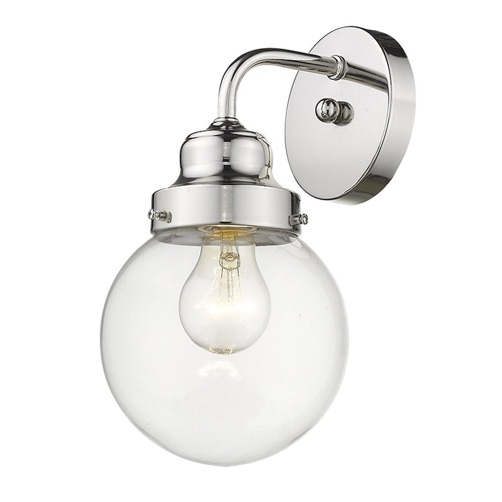 A silver wall sconce with a clear glass globe shade and exposed bulb, mounted on a white background.