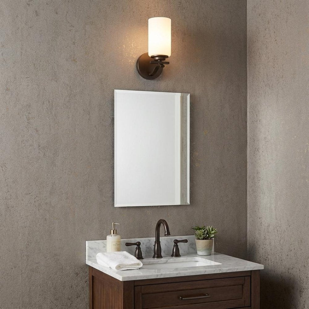 One Light Bronze and Glass Wall Sconce in a home interior