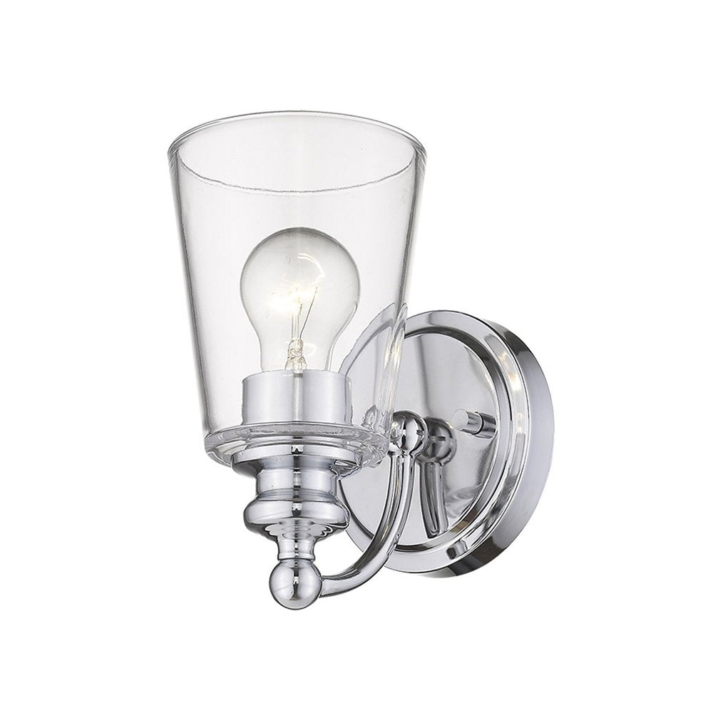 A chrome wall sconce with a clear glass shade and a visible light bulb against a white background.