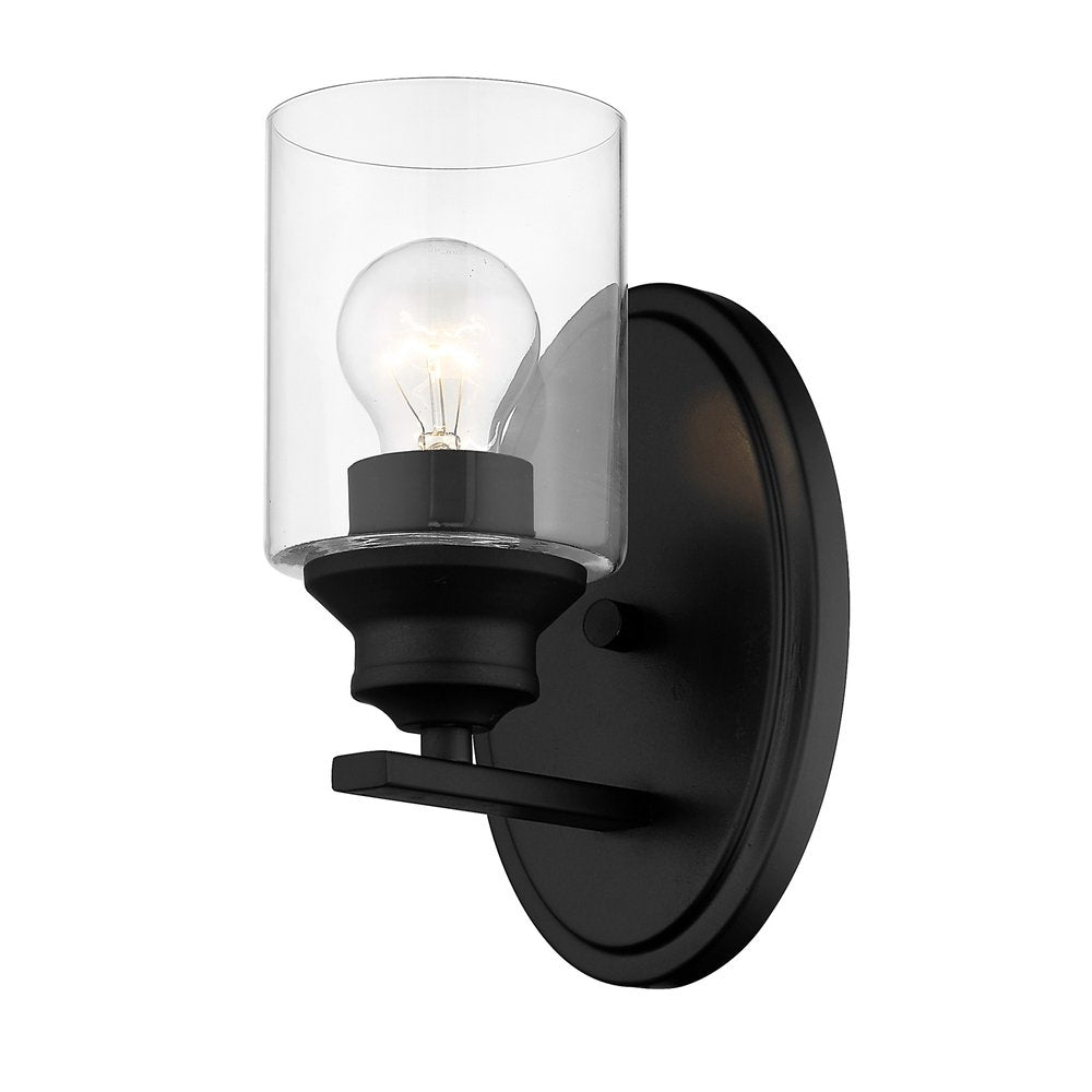 Matte black wall light with a clear glass shade and exposed bulb, set against a white background.
