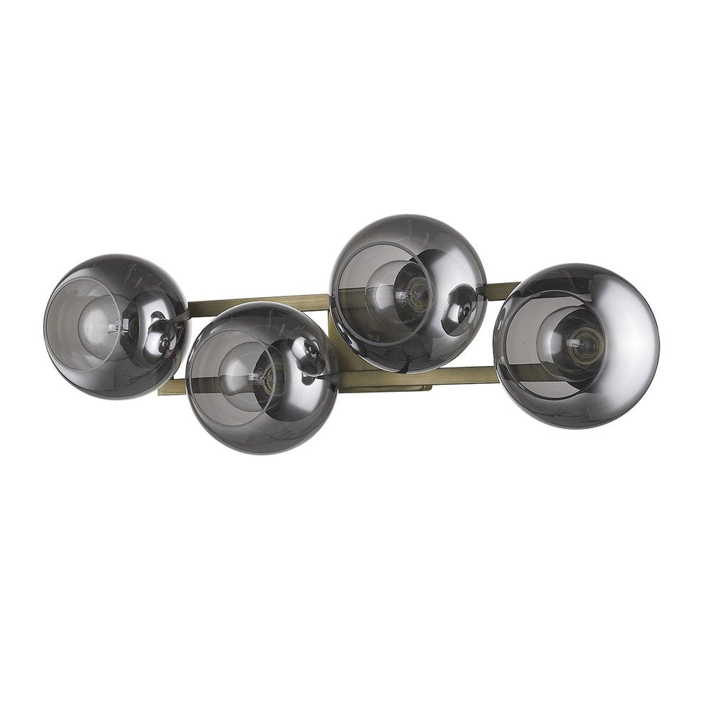Aged brass sconce with four smoked glass globe shades on a white background.