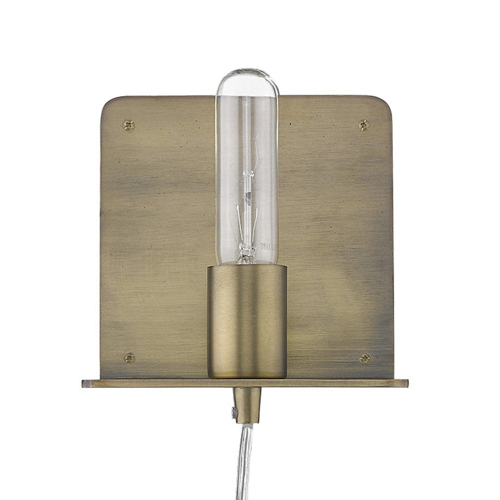 A petite dull gold shelf wall light with a clear Edison bulb, mounted on a white background.