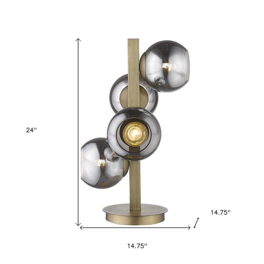 24" Brass Metal Four Light Novelty Table Lamp With Silver Metallic Globe Shades. Table lamp isolated on a plain white background, showing a silver metal surface.