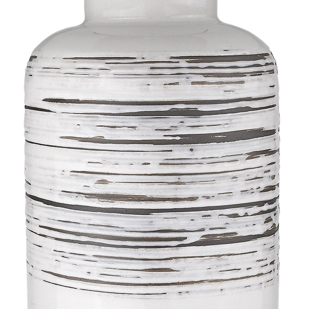 25" Black and White Ceramic Column Lamp With White Drum Shade. Lamp isolated on a plain white background, finished in white ceramic.