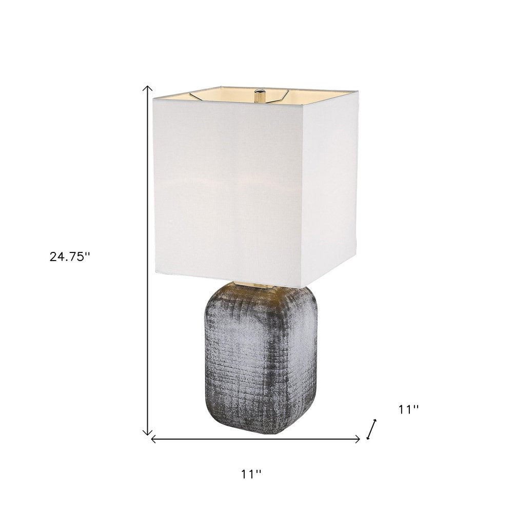 25" Blue and Gray Ceramic Table Lamp With White Square Shade. Table lamp isolated on a plain white background, showing a white ceramic surface.