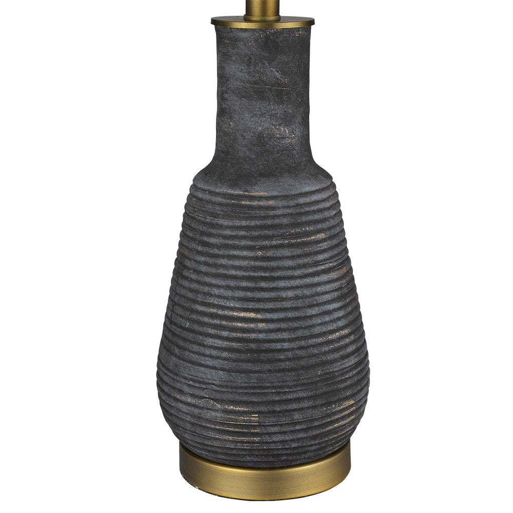 26" Distressed Black and Gold Ceramic Table Lamp With White Drum Shade. Table lamp isolated on a plain white background, in a gold ceramic finish.