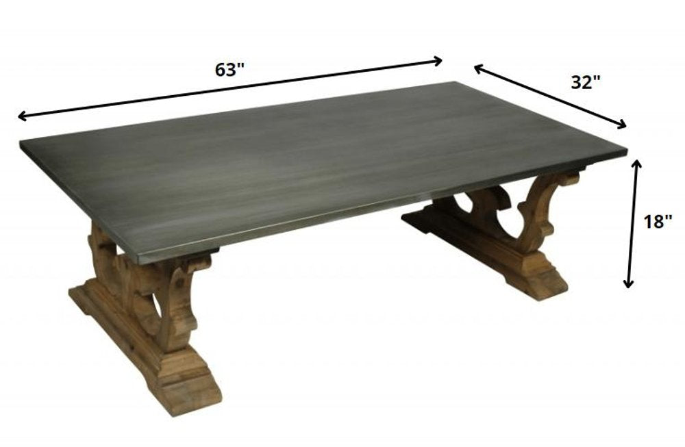 63" Gray and Brown Zinc and Solid Wood Pedestal Coffee Table. Coffee table isolated on a plain white background, showing a gray wood surface.