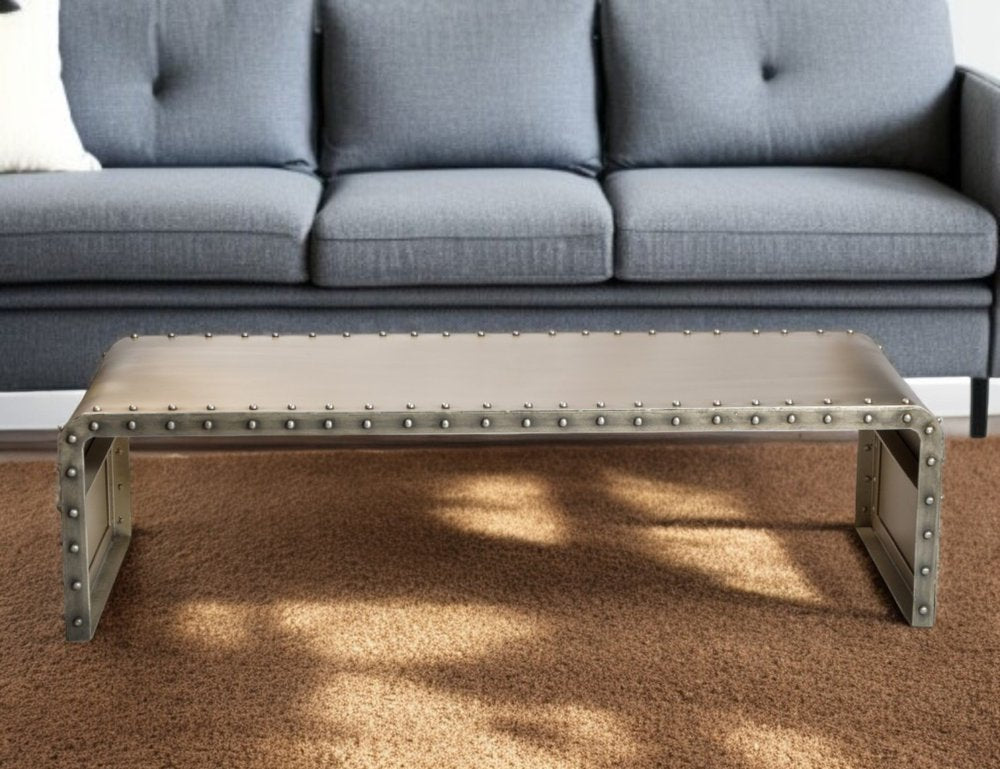 60" Gray Aluminum and Metal Frame Coffee Table shown outdoors on an outdoor setting in gold metal.