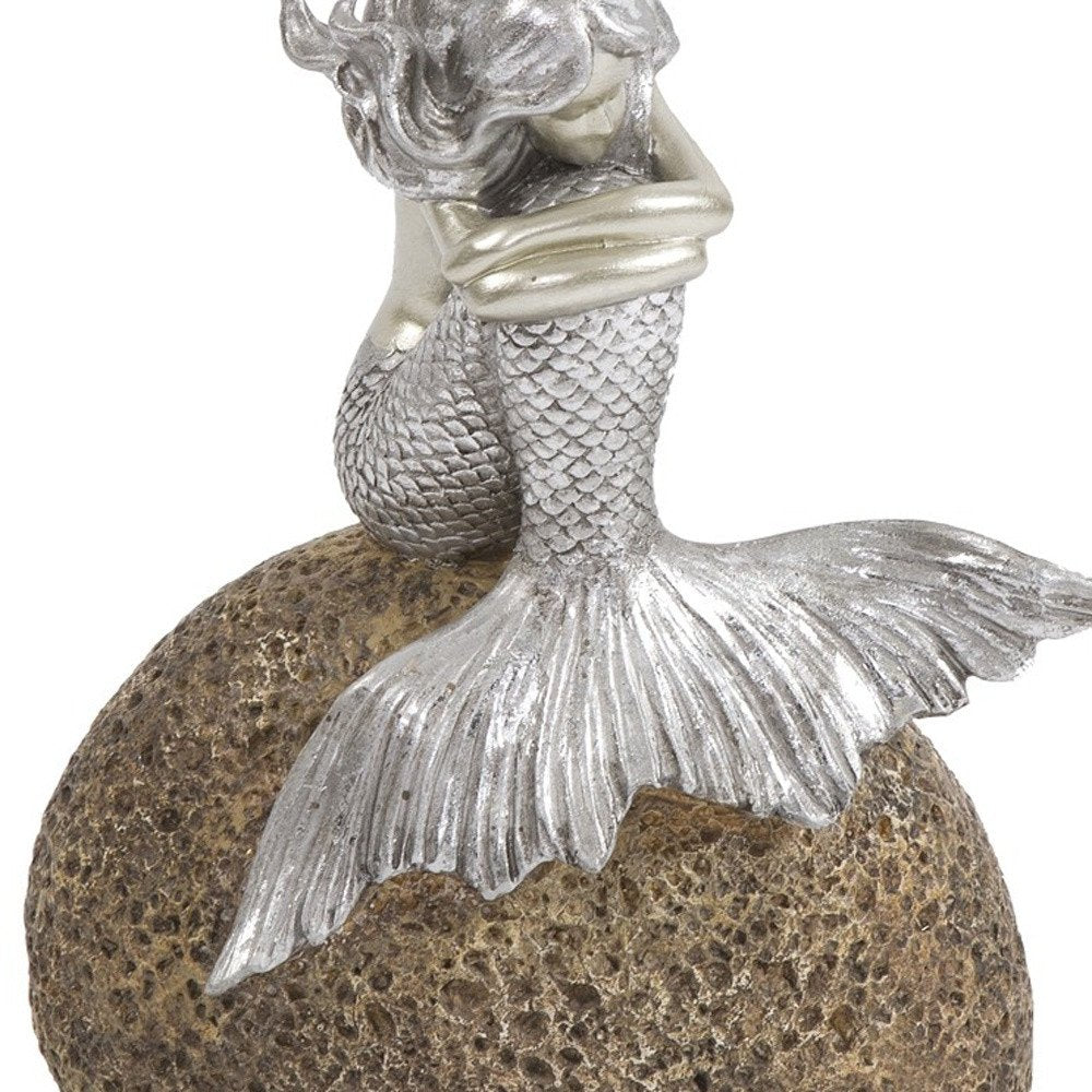 10" Brown and Silver Contemplative Mermaid Resin Tabletop Sculpture. Sculpture isolated on a plain white background, finished in silver resin.
