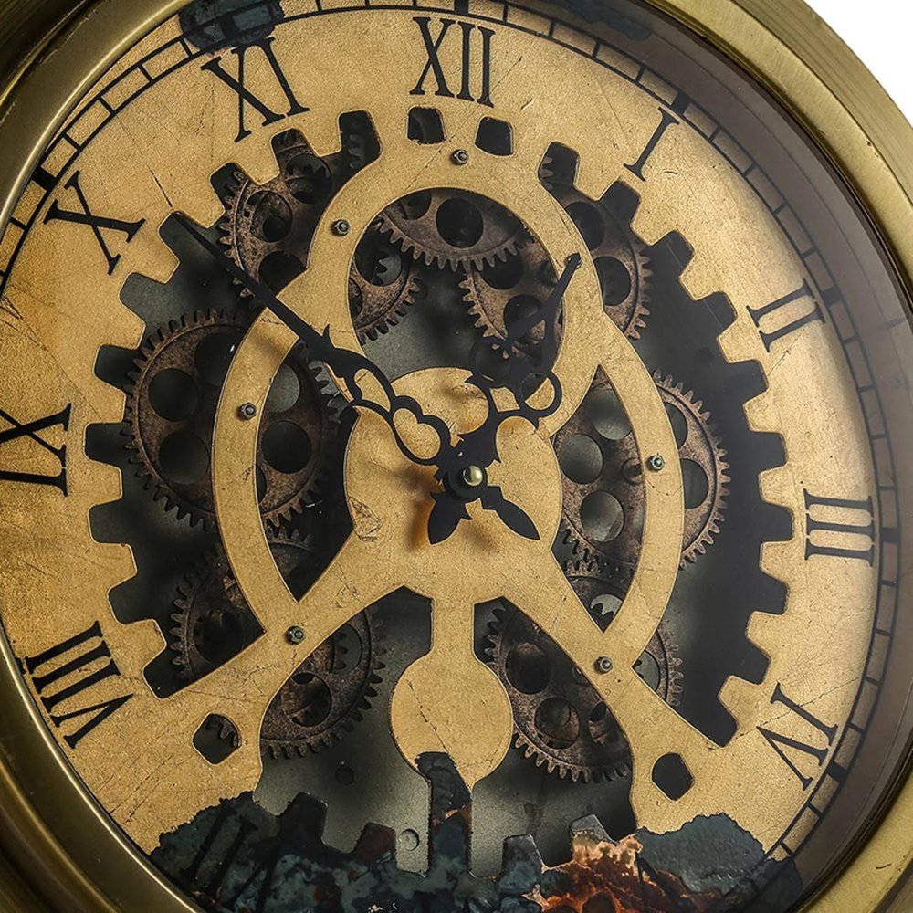 3" Gold Iron Wall Clock styled in a furnished interior with a tan wall on a charcoal floor.