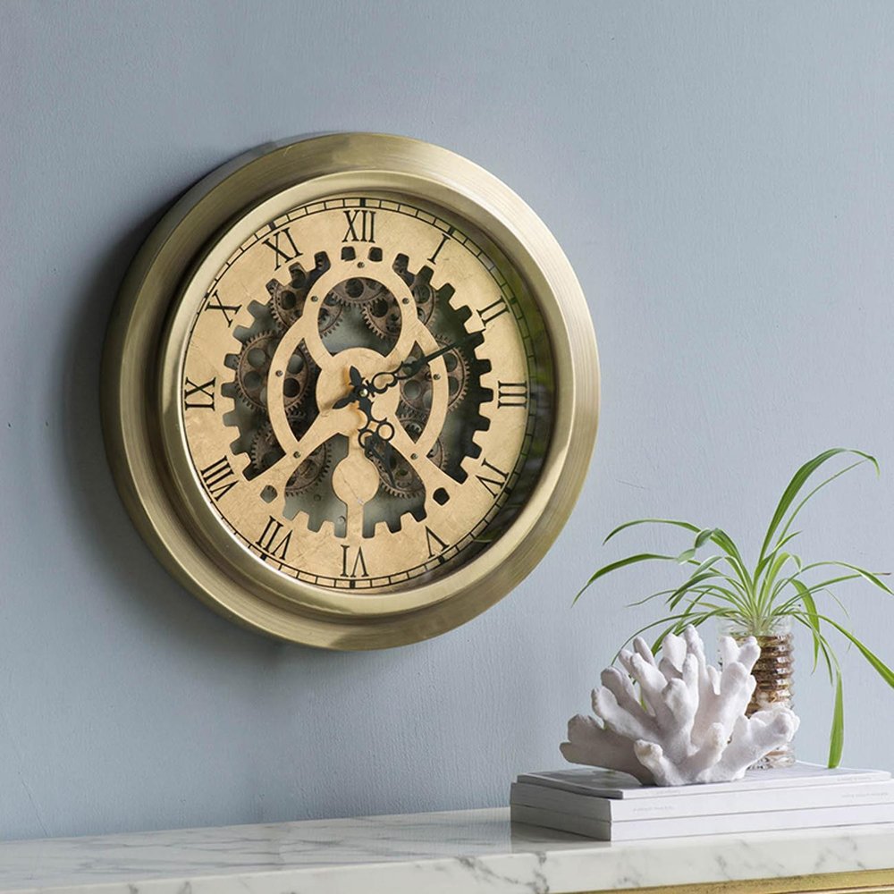 3" Gold Iron Wall Clock shown outdoors on a tiled patio.