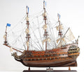 27" Brown Solid Wood Hand Painted Boat Model Boat. Sculpture isolated on a plain white background, showing a brown wood surface.