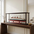 15" Black And Red Solid Wood Hand Painted Boat Model Boat styled in a furnished interior with an off-white wall on a wood floor.