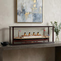 15" Black And Red Solid Wood Hand Painted Boat Model Boat styled in a furnished interior with a light gray wall on a dark wood floor.