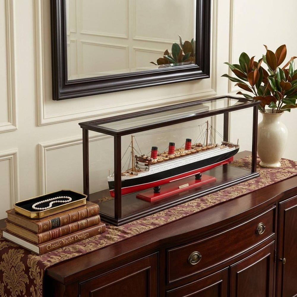 16" Black and Red Solid Wood Hand Painted RMS Queen Mary Medium Display Case Model Boat styled in a furnished interior with a cream wall on a black floor.