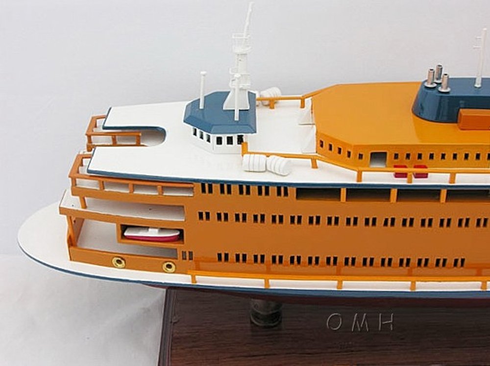 11" Maroon Staten Island Ferry Boat Hand Painted Decorative Boat styled in a furnished interior with an off-white wall on a off-white floor in orange.