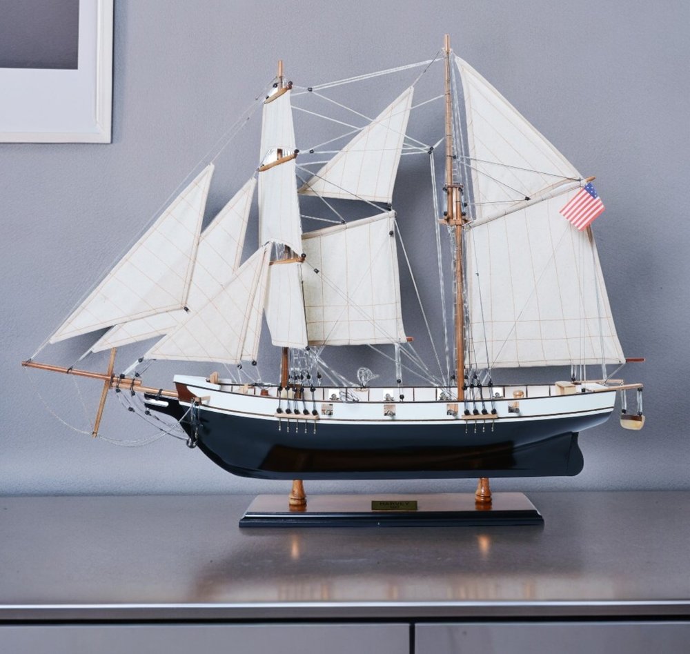 26" Black and White Solid Wood Hand Painted p-Oxybis(benzenesulfonyl hydrazide) Model Boat shown outdoors on a tiled patio.