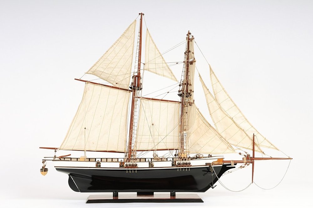 26" Black and White Solid Wood Hand Painted p-Oxybis(benzenesulfonyl hydrazide) Model Boat. Home product isolated on a plain white background, showing a black wood surface.