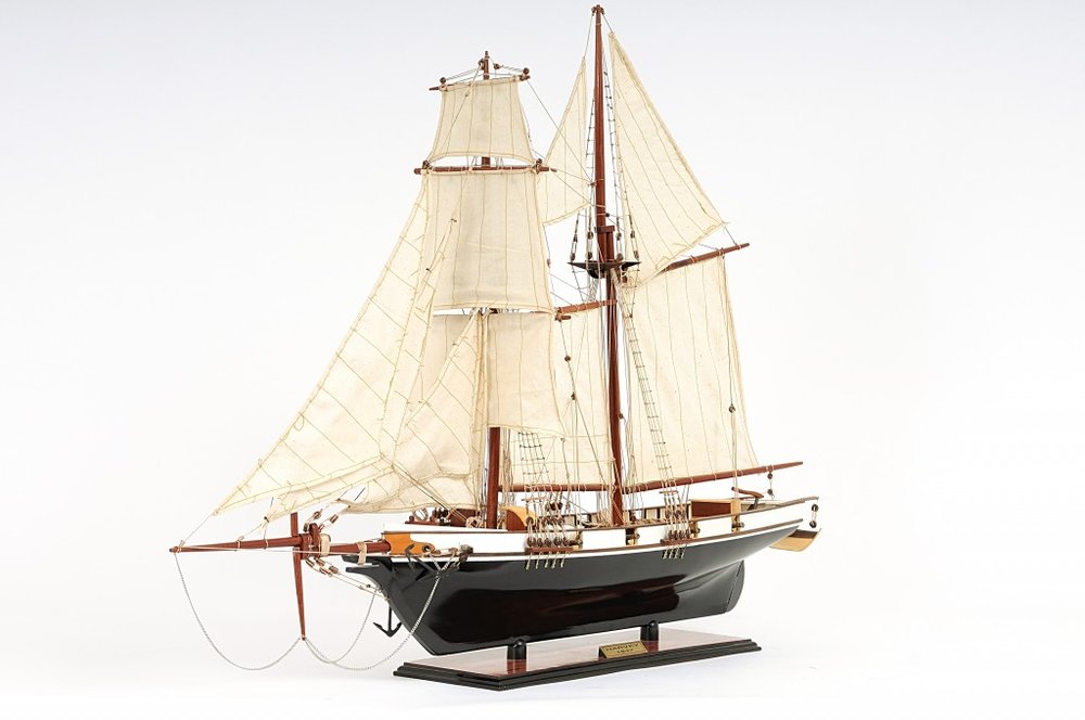 26" Black and White Solid Wood Hand Painted p-Oxybis(benzenesulfonyl hydrazide) Model Boat. Home product isolated on a plain white background, showing a black wood surface.