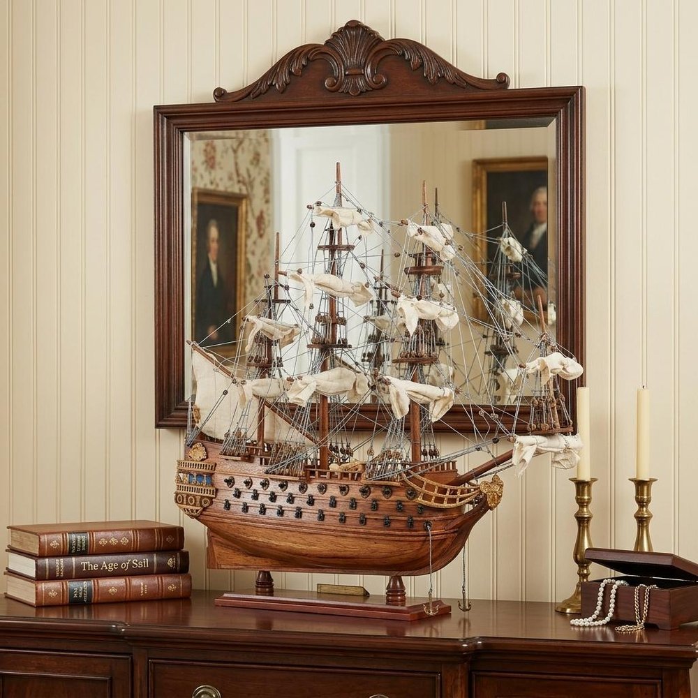 18" Wood Brown Solid Wood Hand Painted San Felipe 1690 Small Model Boat styled in a furnished interior with a cream wall on a dark wood floor.