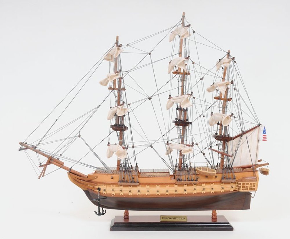 20" Wood Brown Solid Wood Hand Painted 1797 USS Constitution Small Model Boat. Home product isolated on a plain white background, in a brown wood finish.