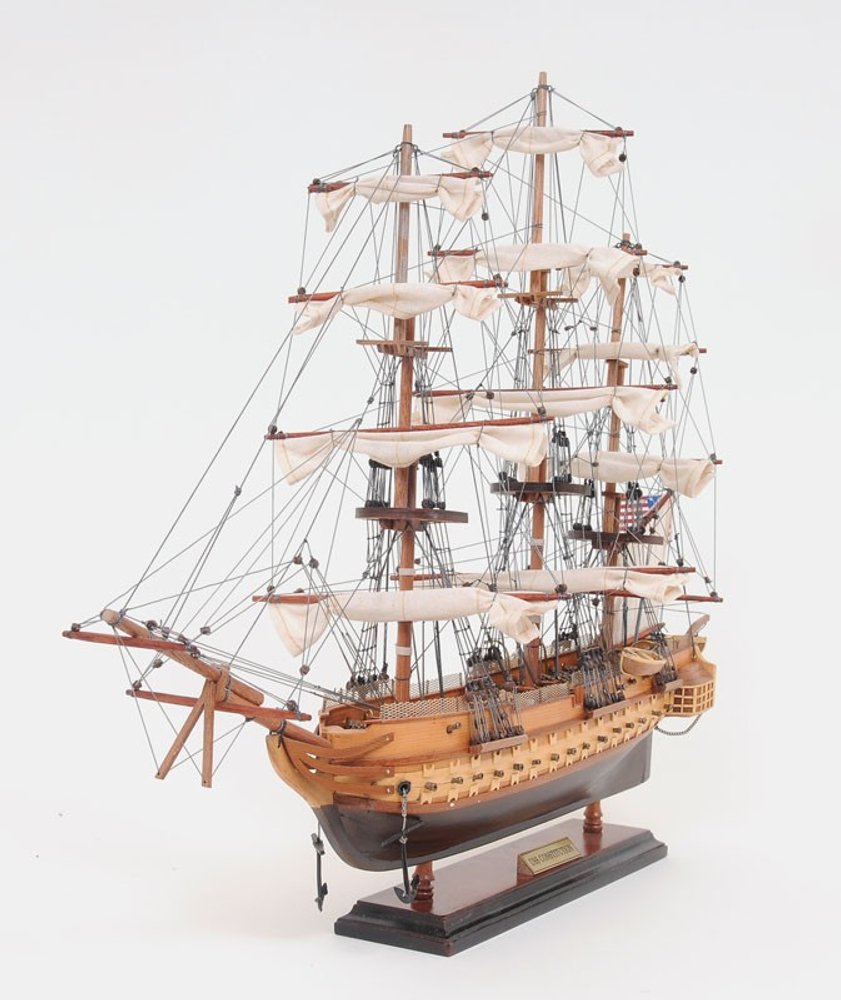 20" Wood Brown Solid Wood Hand Painted 1797 USS Constitution Small Model Boat. Home product isolated on a plain white background, showing a wood surface.