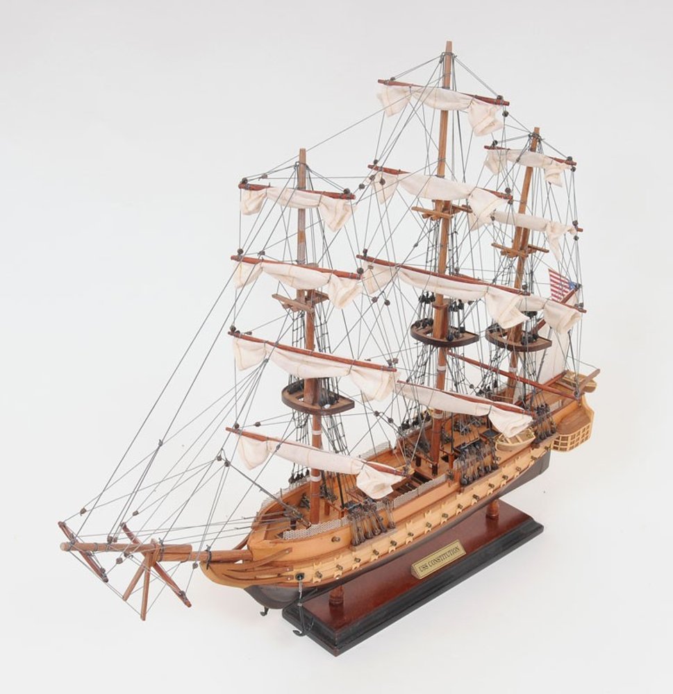 20" Wood Brown Solid Wood Hand Painted 1797 USS Constitution Small Model Boat. Home product isolated on a plain white background, showing a brown wood surface.