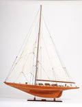 49" Brown Solid Wood Hand Painted Model Boat. Sculpture isolated on a plain white background, finished in brown wood.