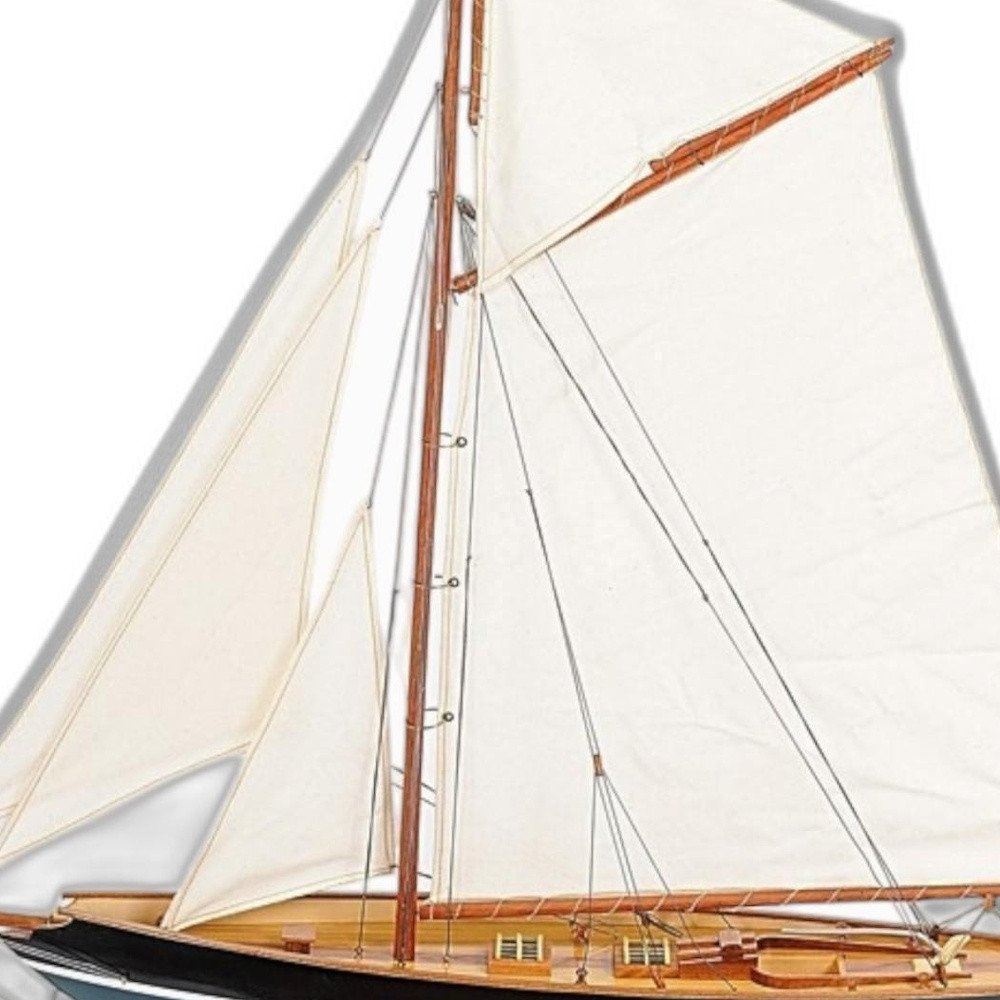 31" Black Blue And White Solid Wood Pen Duick Hand Painted Model Sail Boat. Home product isolated on a plain white background, finished in white wood.