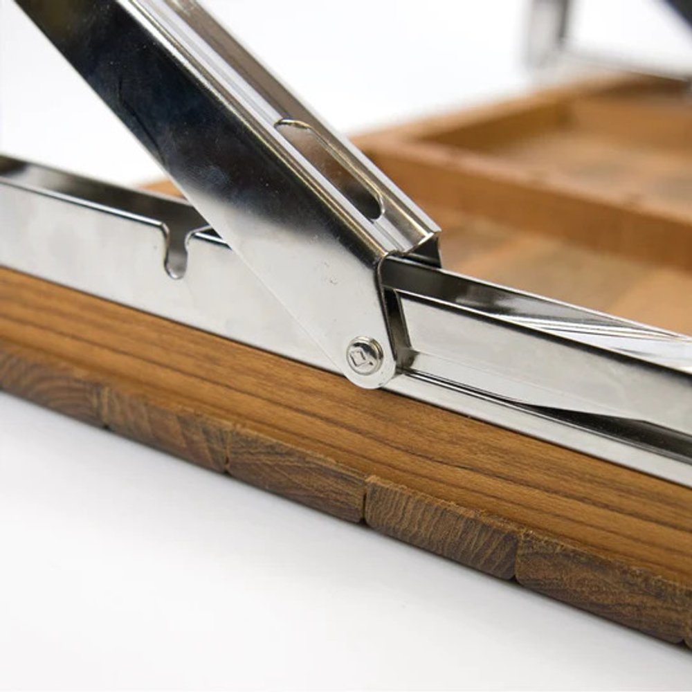 Close-up of a shiny metal hinge attached to a brown teak wood shower bench, showing the product's material and construction.