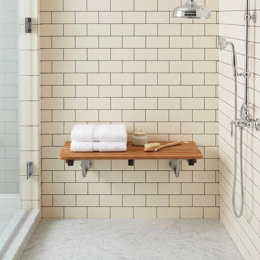 28" Brown Premium Wall Mount Teak Shower Bench. Shower bench isolated on a plain white background, showing a brown teak surface.