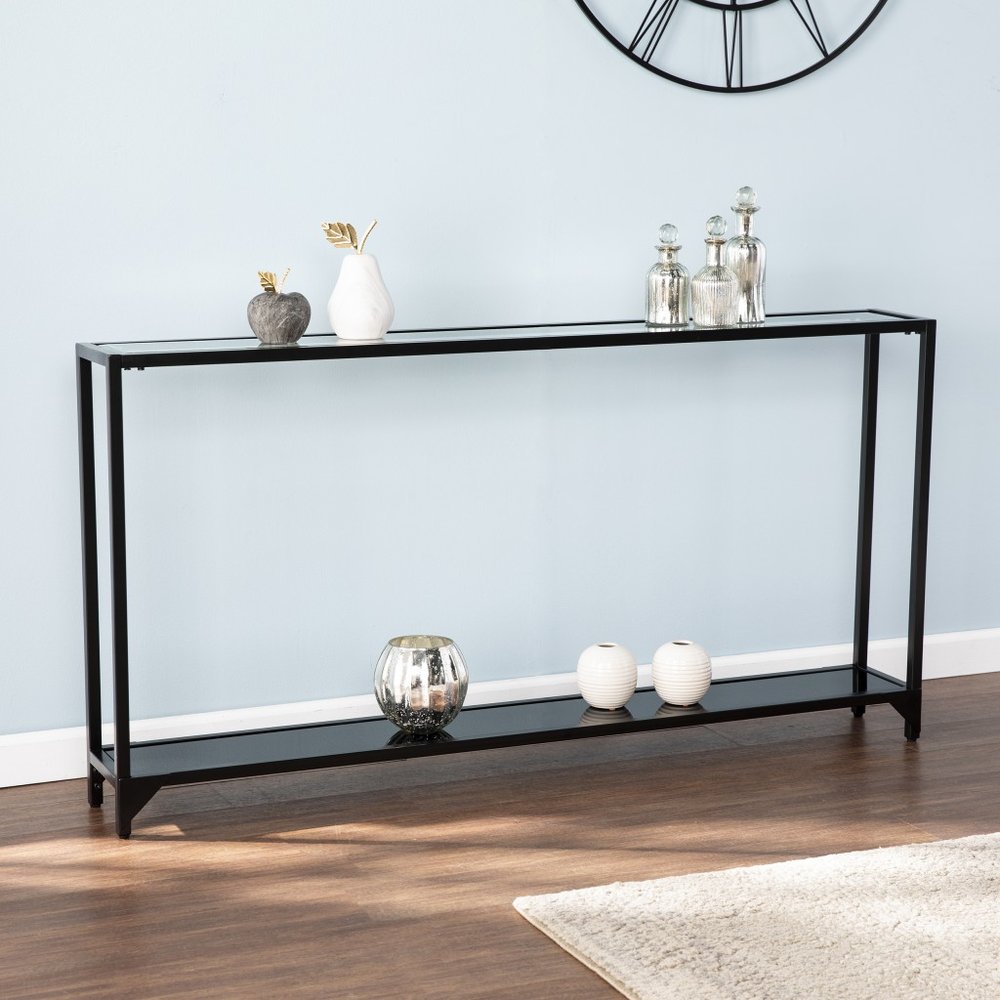 56" Clear and Black Glass Frame Console Table With Shelves shown outdoors on an outdoor setting.