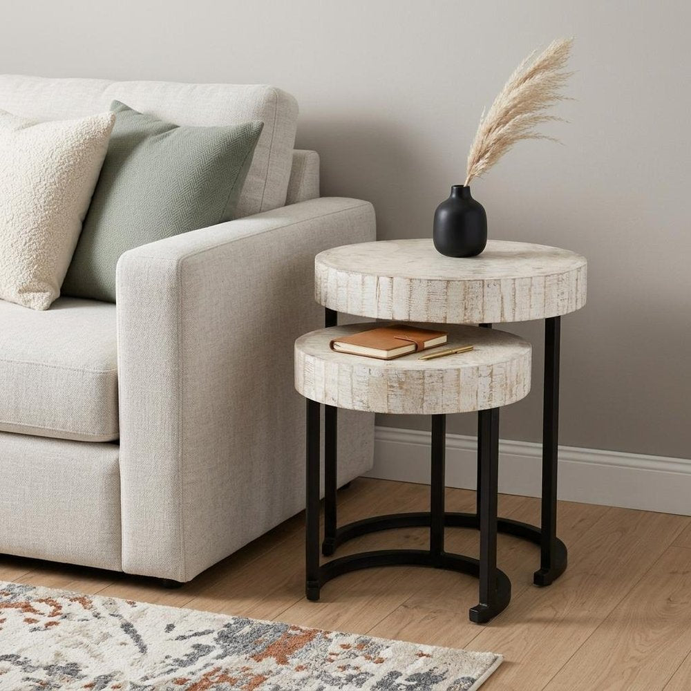 Set Of Two 21" White Solid Wood And Iron Round Nested Tables in a home interior