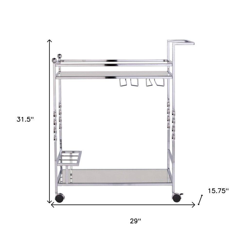 29" Silver Metal and Mirrored Glass Rolling Bar Cart With Wine Storage. Bar cart isolated on a plain white background, in a silver glass finish.