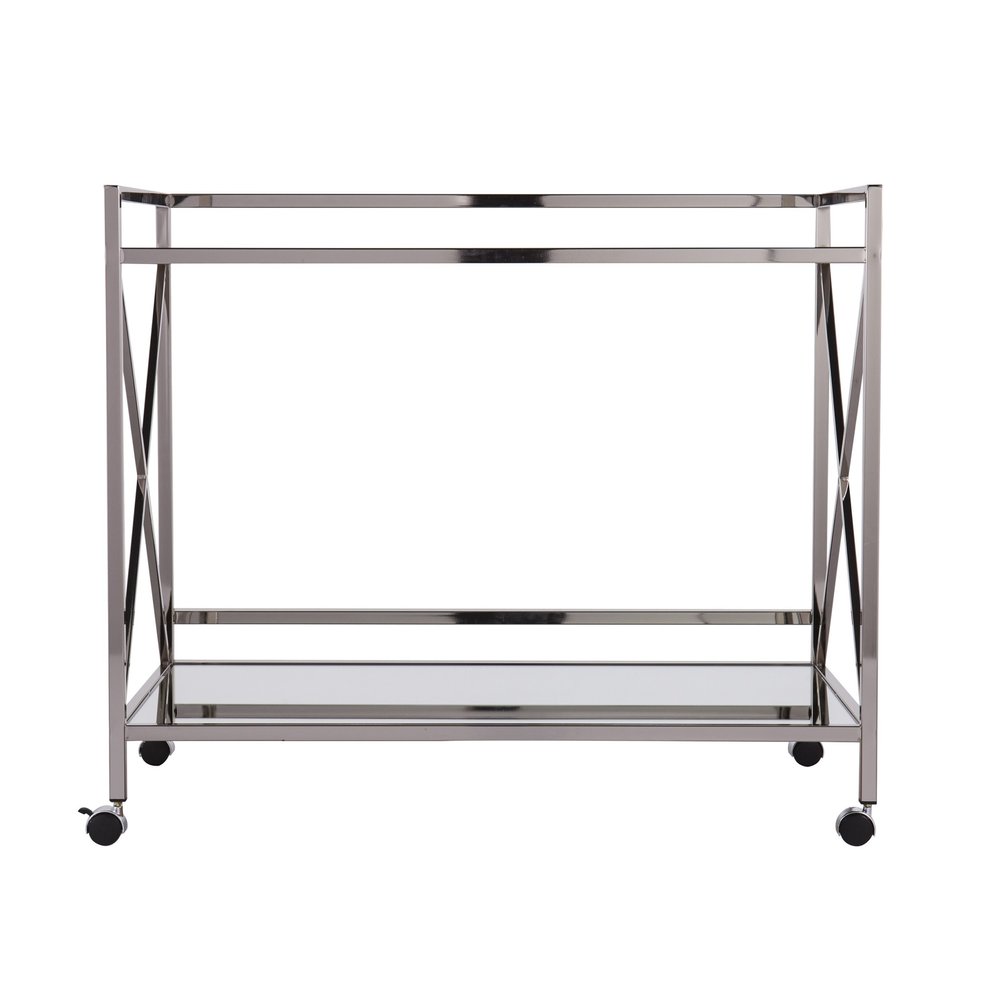 Silver metal bar cart with two glass shelves and four wheels against a white background.