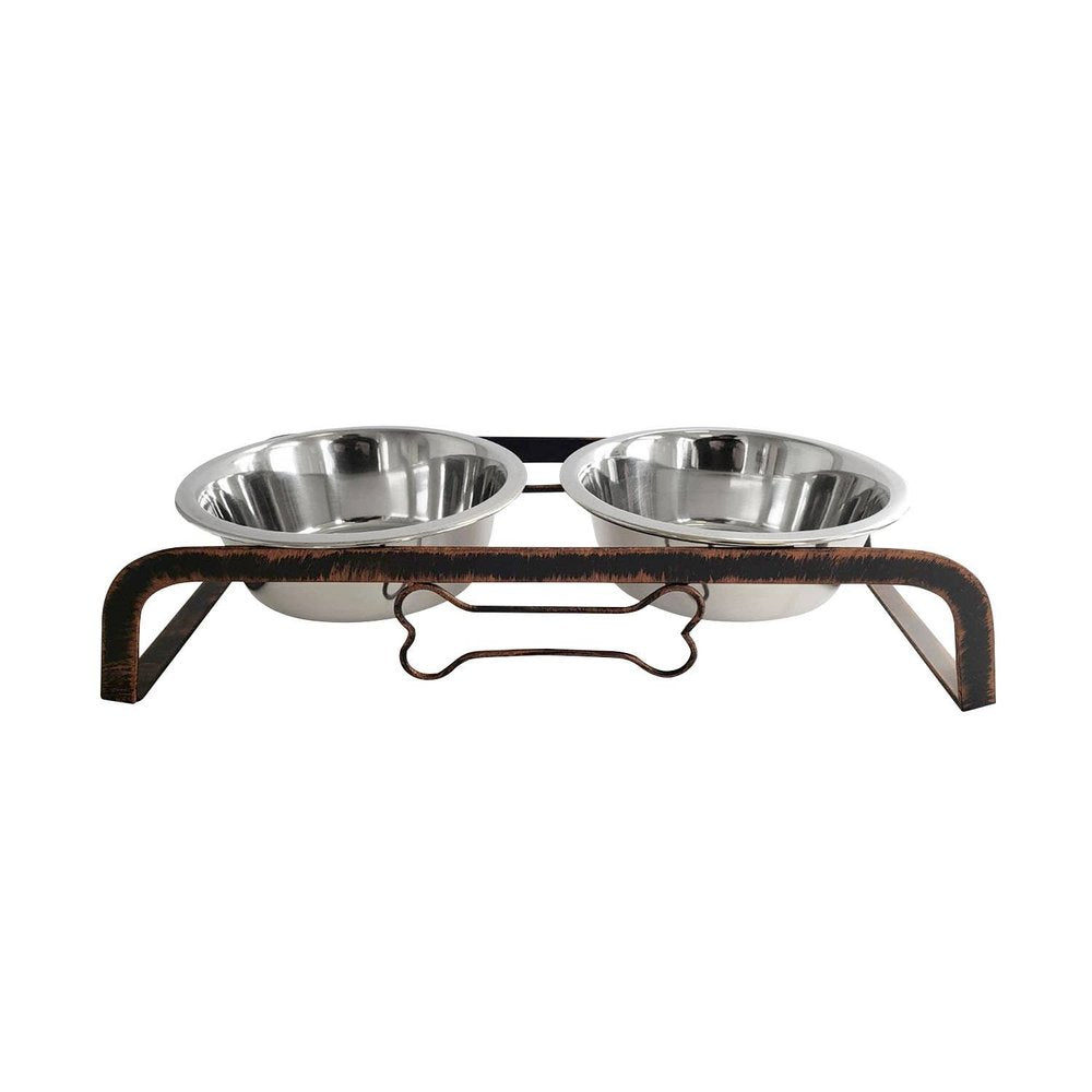Rustic elevated dog feeding station with two stainless steel bowls on a dark metal stand with a bone accent, on a white background.