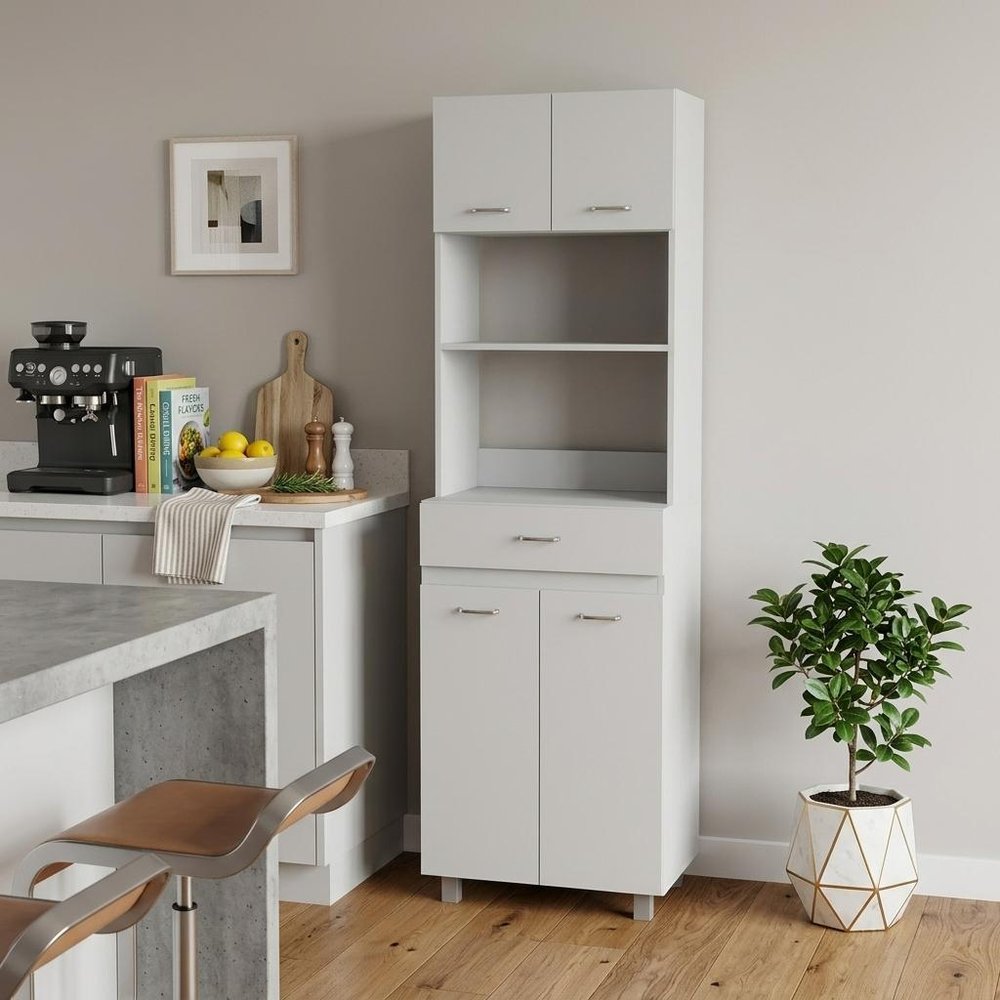 24" White Wood Kitchen Cart With Storage styled in a furnished interior with a light gray wall on a wood floor.