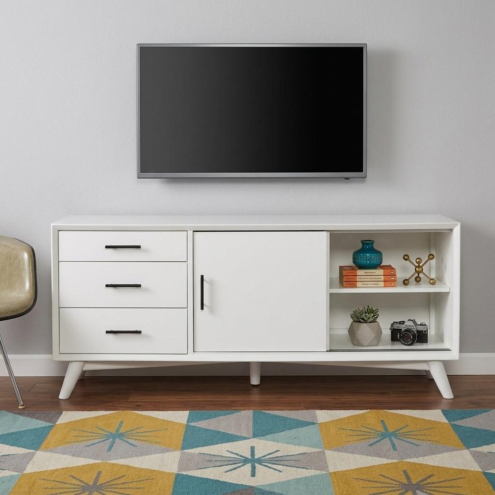 64" White Mahogany Solid Wood Enclosed and Open Storage TV Stand styled in a furnished interior with a light gray wall on a wood floor.