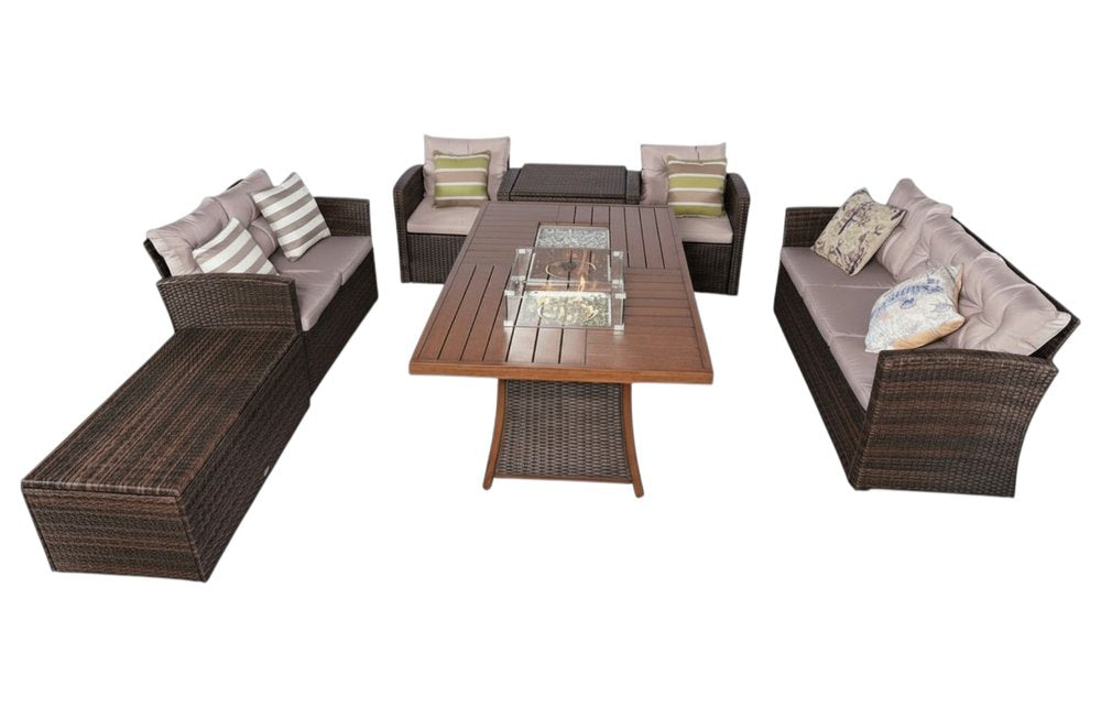 Brown wicker sectional seating group with gray cushions and a fire pit table on a white background.