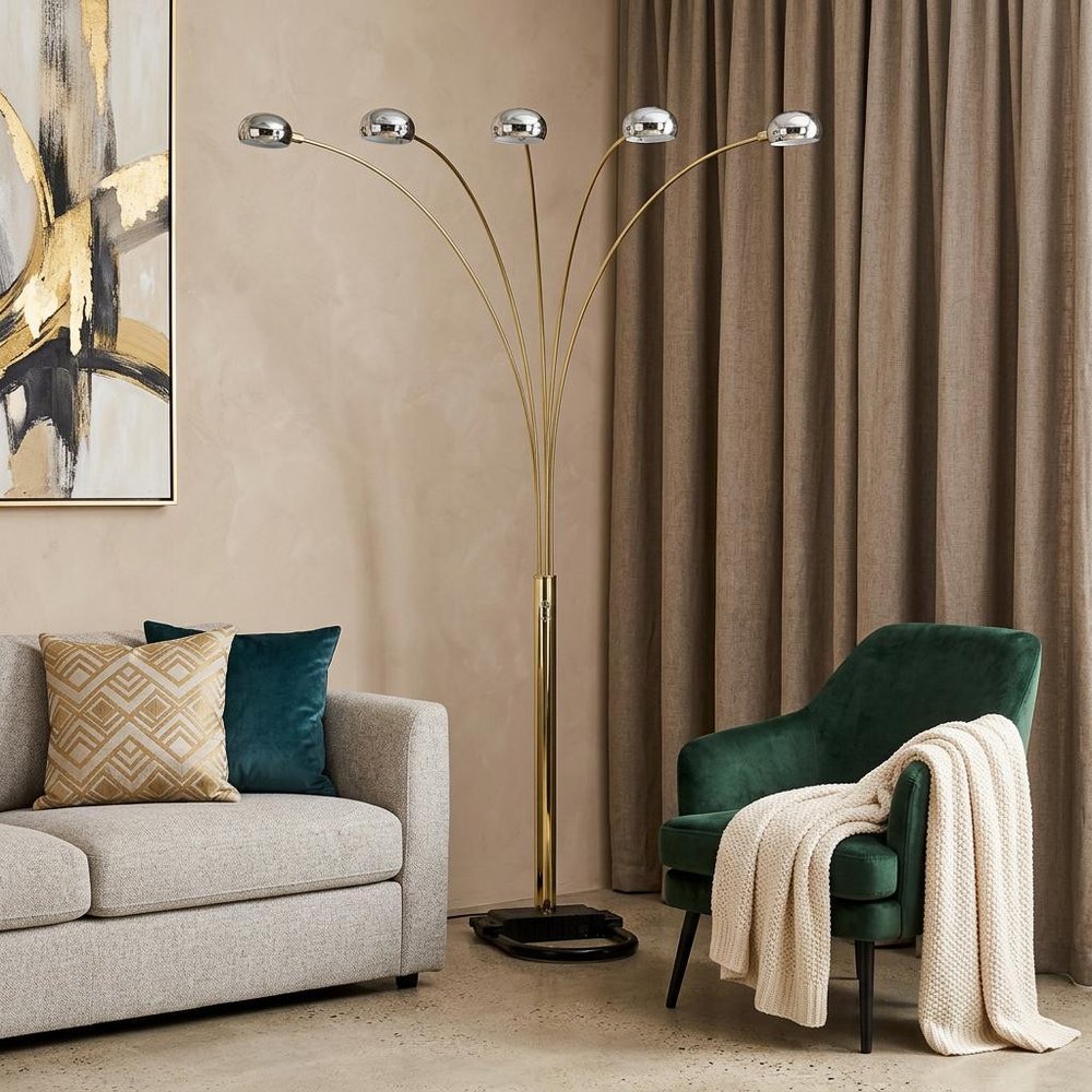 84" Gold Five Light Arc Floor Lamp With Brass Metal Dome Shade in a home interior