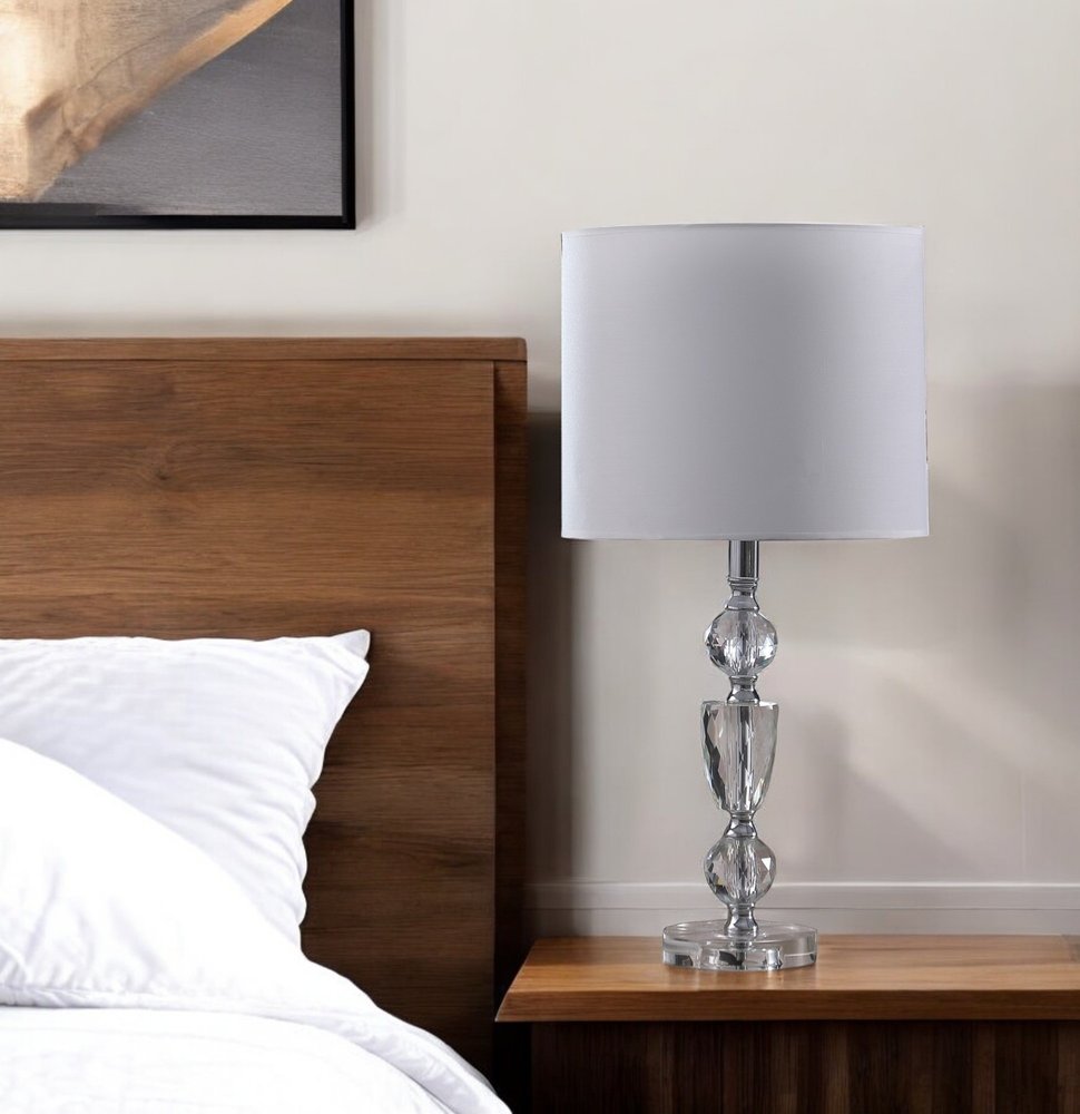 24" Clear And Silver Faux Crystal And Metal Table Lamp With White Drum Shade. Table lamp in silver crystal.