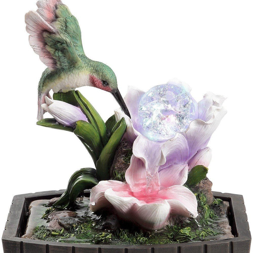 11" Pink Green And Brown Polyresin Hummingbird Tabletop Fountain. Home product isolated on a plain white background, showing a resin surface.